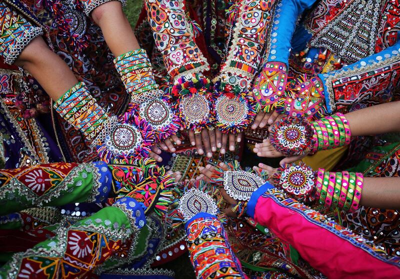 Women dressed in traditional attire display their decorated hands during rehearsals for Garba, a folk dance, ahead of the Navratri festival in Ahmedabad, India. Amit Dave/Reuters