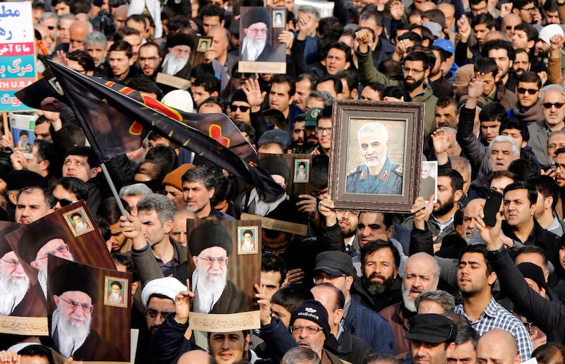 Iranians holding pictures of Khamenei and Suleimani take to the streets during an anti-US demonstration in Tehran. EPA