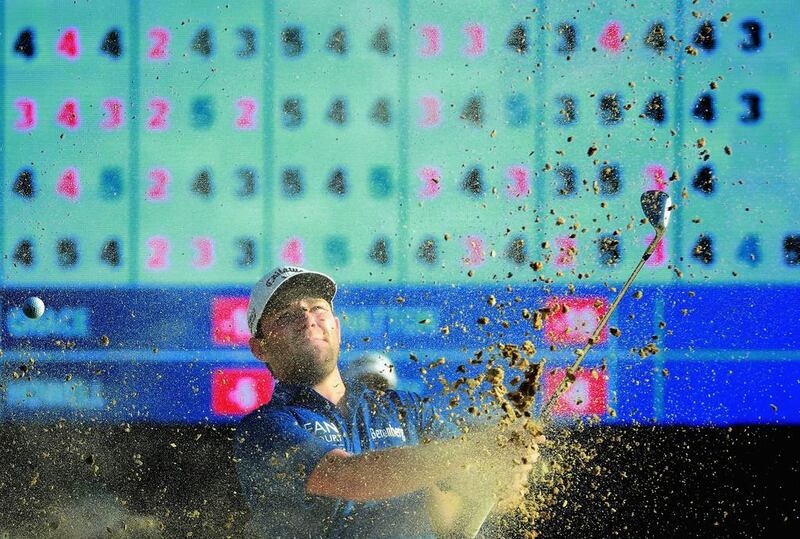 Branden Grace of South Africa plays out of the 18th greenside bunker. Warren Little / Getty Images