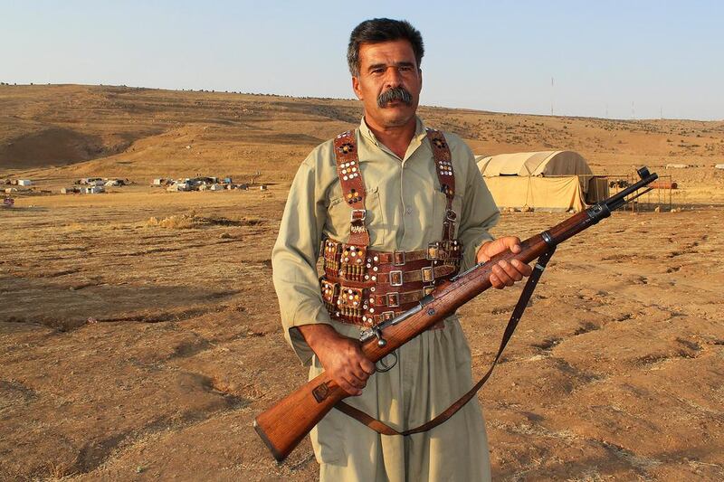  Faris Salih Faris, 48, is ready to defend his people with his WWII-era Soviet rifle. Florian Neuhof for The National