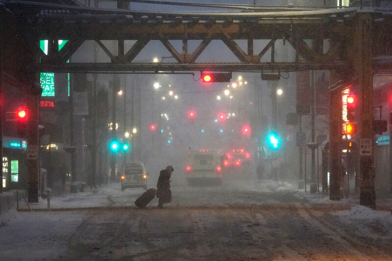 A pedestrian in Chicago earlier this year. La Nina means winter is likely to bring drier than average conditions across US southern states. AP