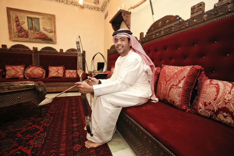 Emirati Salah Al Junaibi shows off a 200-year-old Indian bow and arrow set made of Damascus metal. Mr Al Junaibi has an Islamic and UAE heritage museum in his house in Abu Dhabi. Sarah Dea/The National