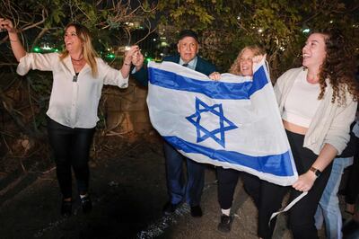 Israelis celebrate as a helicopter with released hostages lands at Tel Aviv's Schneider Medical Centre. AFP