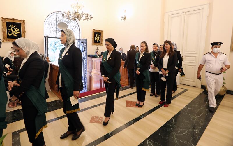 Newly appointed Egyptian judges wait in line at the swearing in ceremony at the State Council headquarters in Giza.