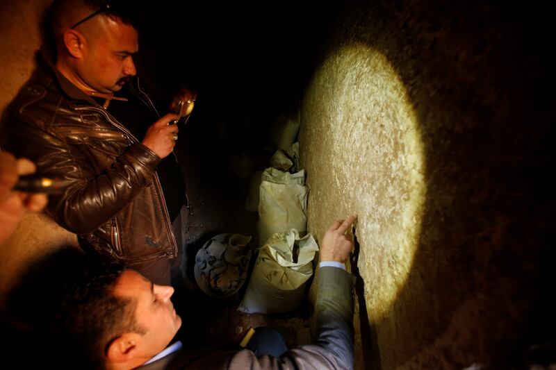 Archaeologist Musab Mohammed Jassim shows discoveries in a tunnel network running under Al Nabi Yunus Mosque. Reuters