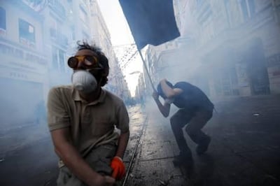 Protestors clash with Turkish riot policemen during a protest against the demolition of Taksim Gezi Park on May 31, 2013, in Taksim quarter of Istanbul. Police reportedly used tear gas on early May 31 to disperse a group, who were standing guard in Gezi Parki to prevent the Istanbul metropolitan municipality from demolishing the last remaining green public space in the center of Istanbul as a part of a major  renewal project of Taksim. AFP PHOTO/BULENT KILIC