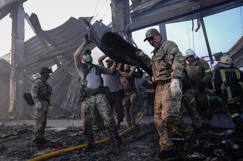 Rescuers search through the rubble at the site of a shopping centre struck by a Russian missile, in Kremenchuk, Ukraine. Reuters