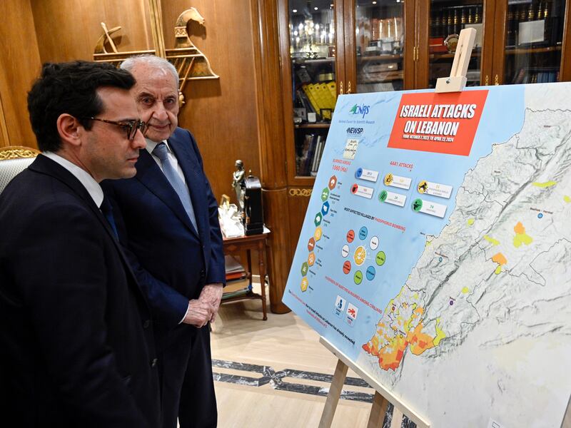 Lebanese Parliament Speaker Nabih Berri, right, shows French Foreign Minister Stephane Sejourne a map of Israeli attacks on Lebanon during their meeting in Beirut on Sunday. EPA