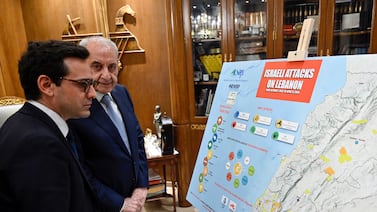 Lebanese Parliament Speaker Nabih Berri, right, shows French Foreign Minister Stephane Sejourne a map of Israeli attacks on Lebanon during their meeting in Beirut on Sunday. EPA