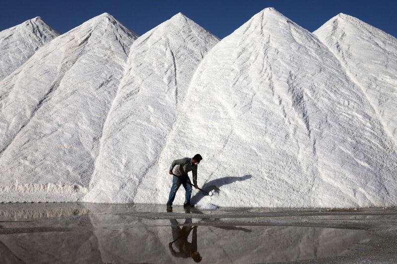 A Turkish worker at the Koyuncu facility shovels large piles of salt at Lake Tuz in Ankara. AFP