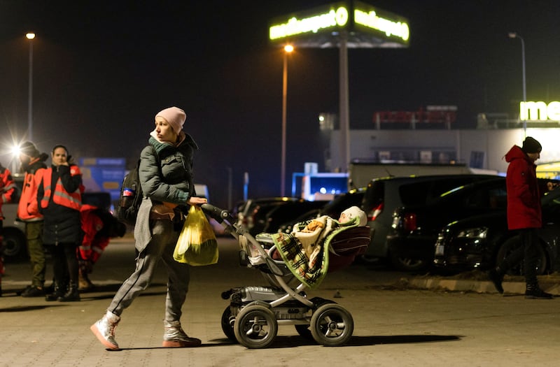 Nadia, a Ukrainian woman, walks around with her baby in a car park in Przemysl, Poland as she waits for help with transport and accommodation. Reuters