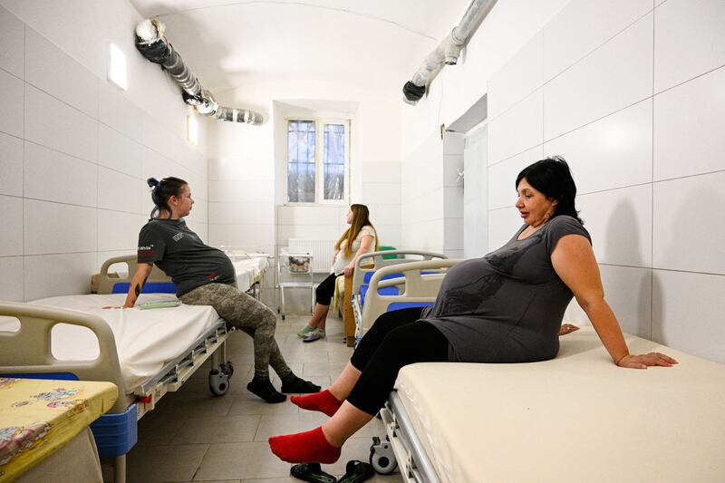 Pregnant women sit in the maternity ward of a Lviv hospital during an air strike alert in Ukraine. AFP