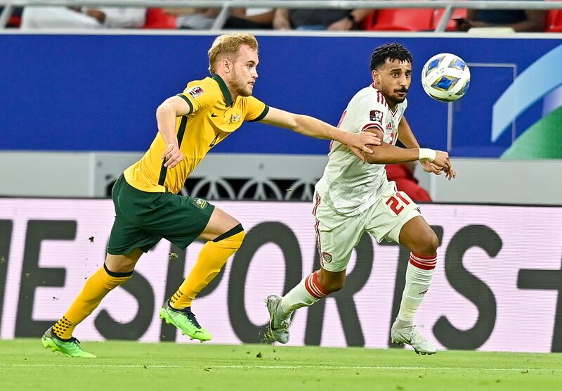 Nathaniel Atkinson of Australia vies for the ball with UAE's Harib Abdallah. EPA