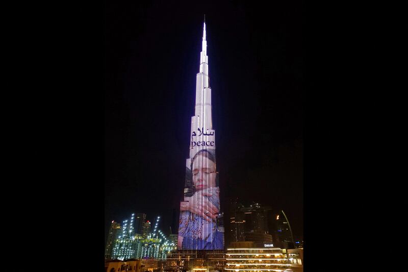 Burj Khalifa in Dubai is lit up with an image of Ms Ardern, in appreciation of her support for New Zealand's Muslim community. AFP