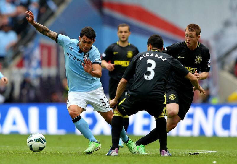LONDON, ENGLAND - MAY 11:  Carlos Tevez of Manchester City evades Antolin Alcaraz of Wigan Athletic during the FA Cup with Budweiser Final between Manchester City and Wigan Athletic at Wembley Stadium on May 11, 2013 in London, England.  (Photo by Alex Livesey/Getty Images)