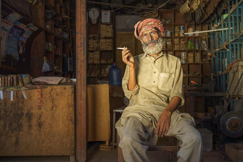 A man takes a cigarette break at a hardware store in Sahiwal, Pakistan. Courtesy Sohail Karmani