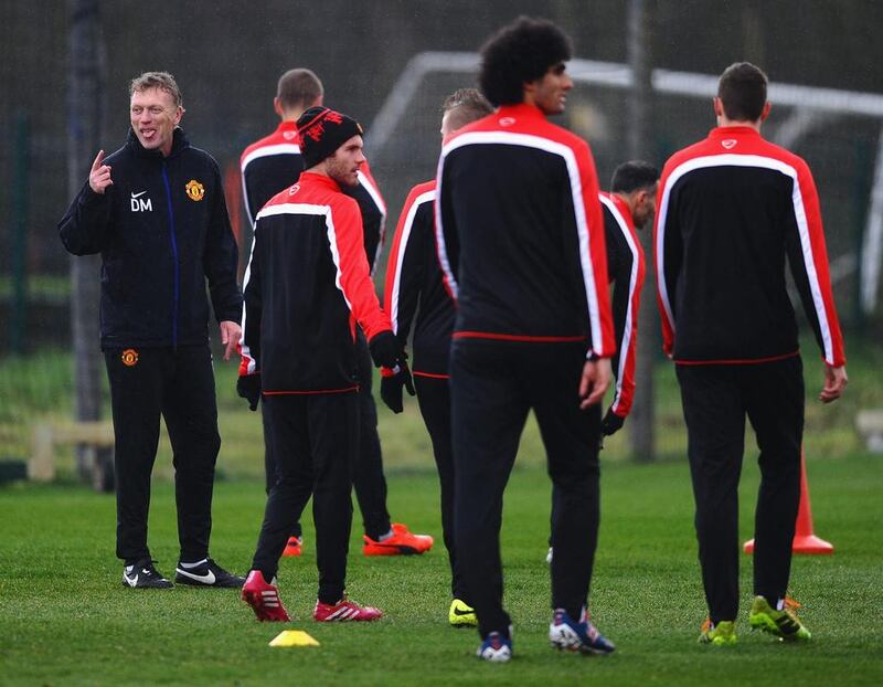 David Moyes of Manchester United jokes with his players during Tuesday's training session. Laurence Griffiths / Getty Images / March 18, 2014