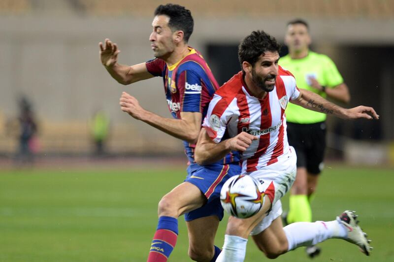 Barcelona midfielder Sergio Busquets battles for possession with Bilbao's Raul Garcia. AFP