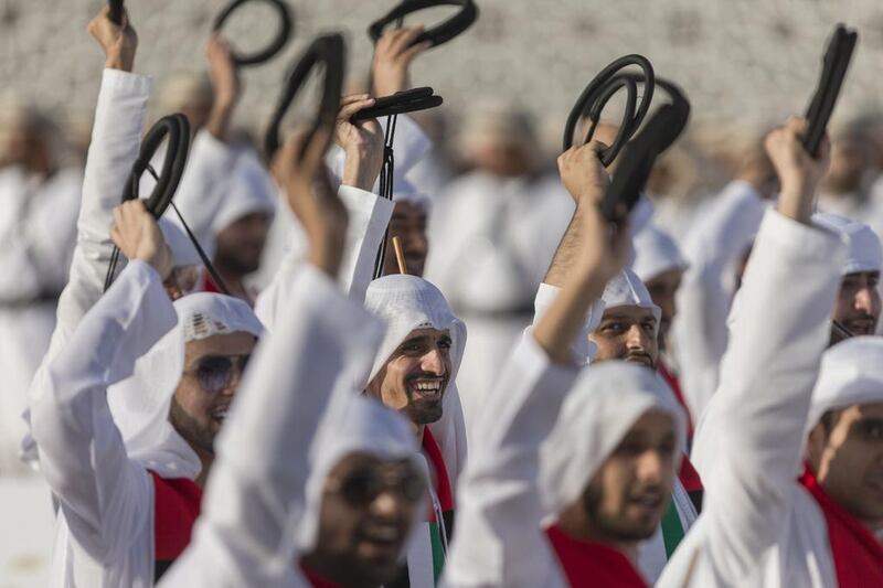 Audience members cheer tribesmen participating in the Union March during the Sheikh Zayed Heritage Festival 2015. Philip Cheung / Crown Prince Court - Abu Dhabi