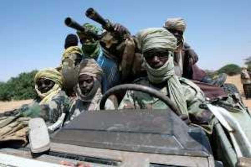 TO GO WITH AFP STORY BY GUILLAUME LAVALLEE<br />(FILES) A picture taken on October 17, 2007 shows fighters of the Sudanese Justice and Equality Movement (JEM) driving their battlewagon through an area on the Sudan-Chad border in northwest Darfur. The six-year Darfur conflict is almost over, Sudan's new pointman for the thorny dossier, Ghazi Salaheddin, said on June 11, 2009, inviting exiled rebel leader Abdel Wahed Mohammed Nur to seize a "historic opportunity" for peace. AFP PHOTO/AMIS/STUART PRICE *** Local Caption ***  158664-01-10.jpg