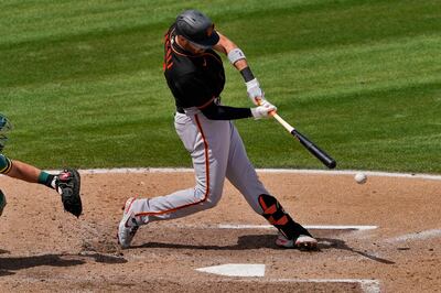 San Francisco Giants' Curt Casali connects for a two RBI double during the third inning of a spring training baseball game against the Oakland Athletics, Monday, March 29, 2021, in Mesa, Ariz. (AP Photo/Matt York)