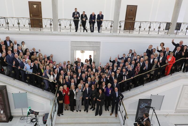 Mr Tusk poses with Civic Coalition members for a group photo at the Sejm, the lower house of parliament, after he was elected Prime Minister. EPA