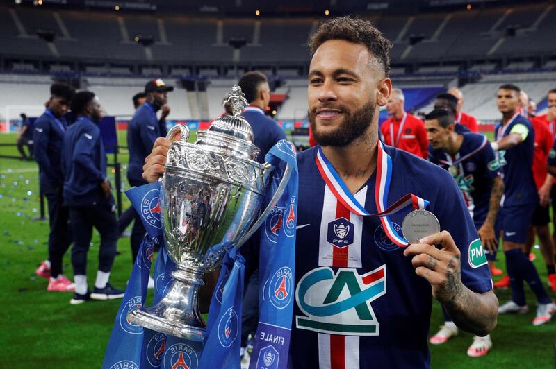 Brazilian forward Neymar celebrates with the trophy after PSG won the French Cup final. AFP