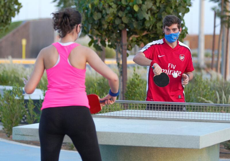 Abu Dhabi, United Arab Emirates, May 26, 2020.  
  Khalifa City residents wearing face masks play ping-pong at Masdar Park during the Covid-19 pandemic.
Victor Besa  / The National
Section:  Standalone / Stock