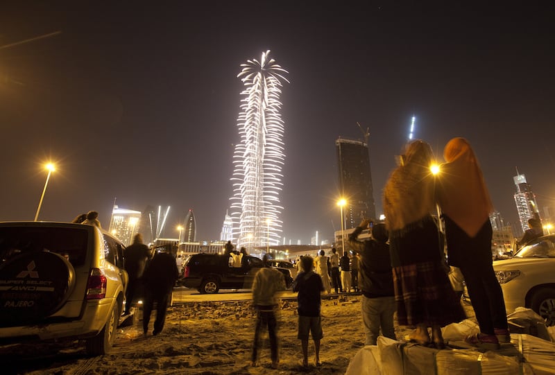 People watch the Burj Khalifa's fireworks display from afar on New Year 2012. Jaime Puebla / The National