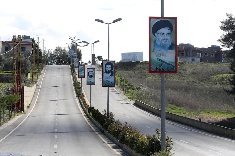 A poster depicting Lebanon's Hezbollah leader Sayyed Hassan Nasrallah, is seen along an empty road during a lockdown and a 24-hour curfew to curb the spread of the coronavirus disease (COVID-19) in Bint Jbeil, southern Lebanon, Lebanon, January 18, 2021. REUTERS/Aziz Taher