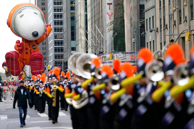 Snoopy follows a marching band. AP