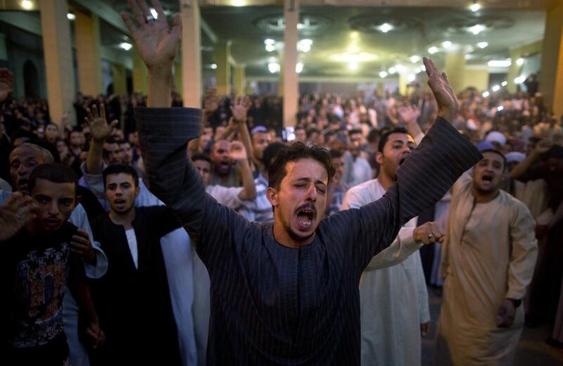 Coptic Christians shout slogans during a funeral service for victims of a bus attack, at Abu Garnous Cathedral in Minya, Egypt. Amr Nabil / AP Photo