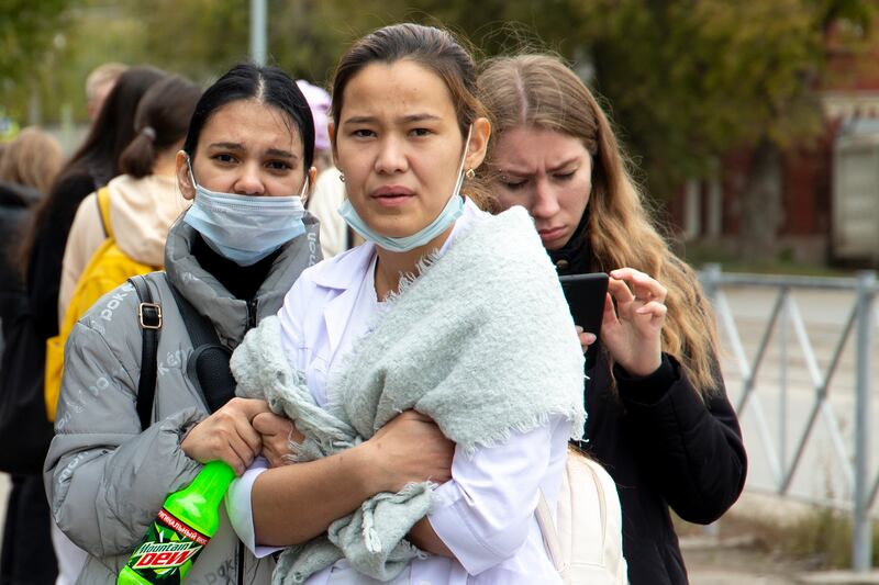 Students gather near the university. AP