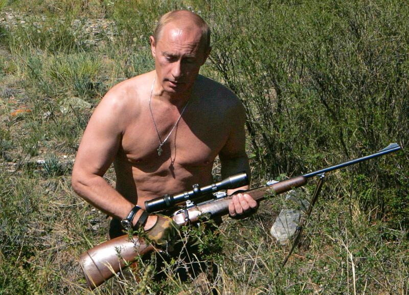 Putin carries a hunting rifle in the Republic of Tuva on August 15, 2007. AFP