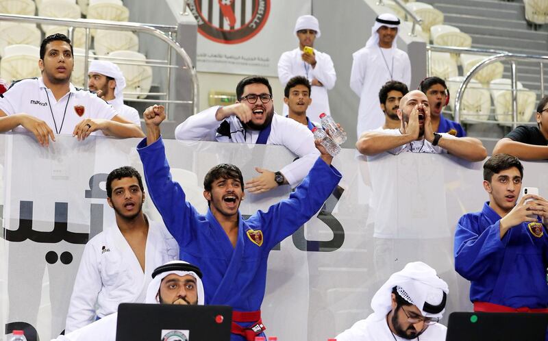 ABU DHABI , UNITED ARAB EMIRATES, September 29 , 2018 :- Team members of Al Wahda cheering for their team during the Jiu-Jitsu President’s Cup Round -1 held at Al Jazira Club Indoor stadium in Abu Dhabi. ( Pawan Singh / The National )  For Sports. Story by Amith