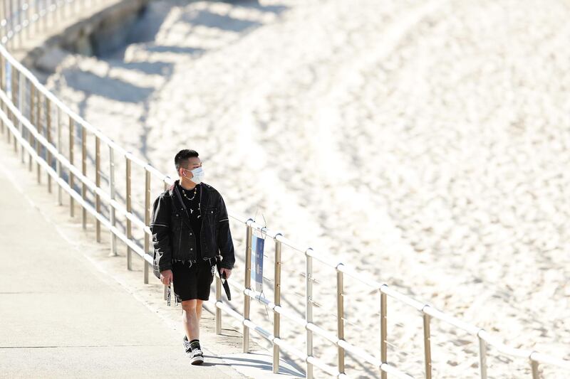 A member of the public is seen wearing a face mask at Bondi Beach in Sydney. Getty Images