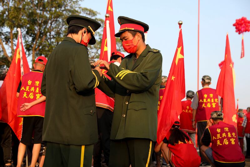 Flag bearers prepare for 73rd National Day celebrations organised by the Taiwan People's Communist Party in Tainan, southern Taiwan, on October 1. AP
