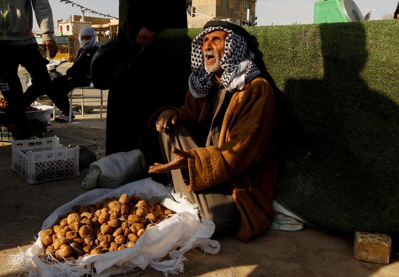 A truffle seller and his wares at a market in Samawa, Iraq. Reuters