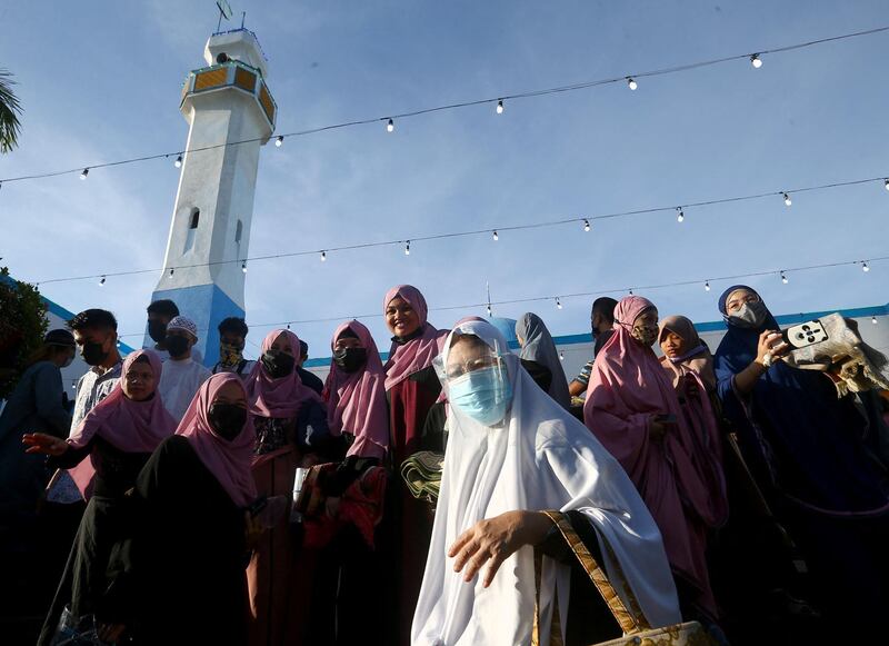 Muslims stand outside a mosque during Eid al-Fitr celebrations in Manila, Philippines. AFP
