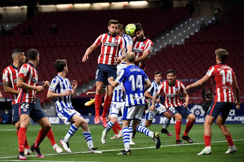 Atletico Madrid midfielder Saul Niguez jumps to head the ball. AFP