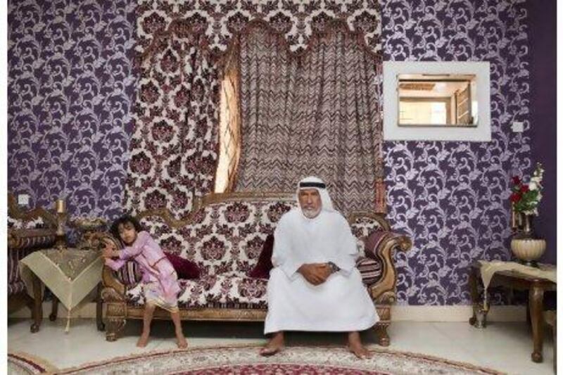 Capt Mohamed Ahmed, 55, with one of his daughters, at his house in Fujairah.
