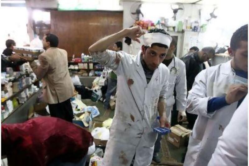 Volunteers struggle to save lives in Cairo, relying on donations of medical supplies, and work while live bullets fly overhead in Tahrir Square, but say they are determined to carry on.