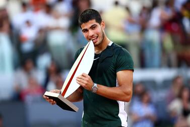 MADRID, SPAIN - MAY 08: Carlos Alcaraz of Spain poses for photographs with the troph after his straight sets victory during the Men's Singles final match against Alexander Zverev of Germany during day eleven of Mutua Madrid Open at La Caja Magica on May 08, 2022 in Madrid, Spain (Photo by Clive Brunskill / Getty Images)