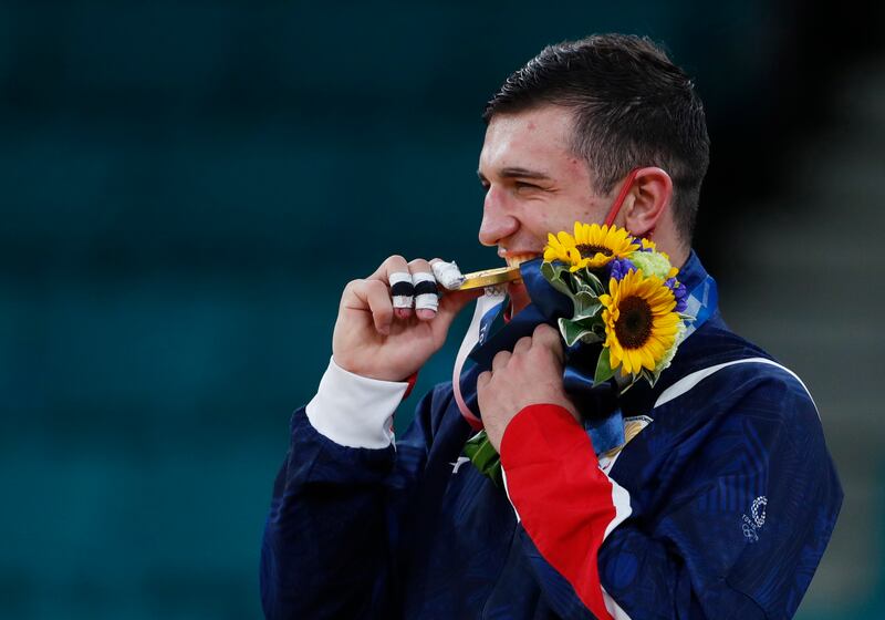 Gold medal winner Lasha Bekauri of Gerogia celebrates at the men's judo -90kg medal ceremony.