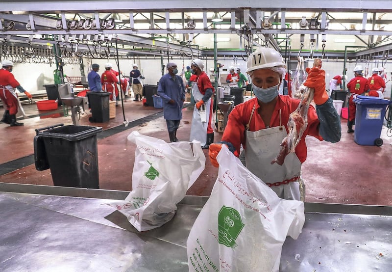 Abu Dhabi, U.A.E., August 22 , 2018.  Livestock shoppers for the second day of Eid Al Adha at the Abu Dhabi Livestock Market and the Abu Dhabi Public Slaughter House (Abu Dhabi Municipality) at the  Mina area.--  Bagging the cut meat.
Victor Besa/The National
Section:  NA
For:  stand alone and stock images