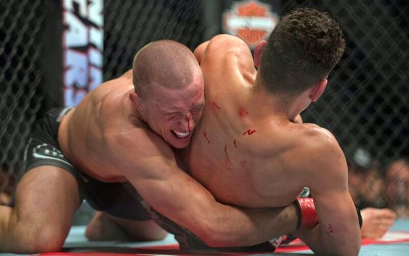 Georges St. Pierre keeps Nick Diaz under control at UFC 158.  Pic: Graham Hughes/AP