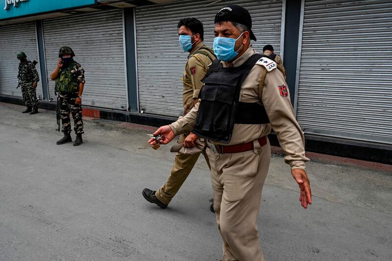 Security personnel and police on patrol in Srinagar.  AFP