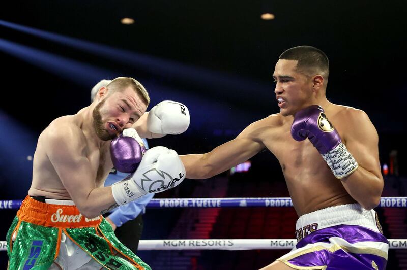 Gabriel Flores Jr. knocks down Matt Conway in the first round during their junior lightweight bout at MGM Grand Garden Arena in Las Vegas.  AFP