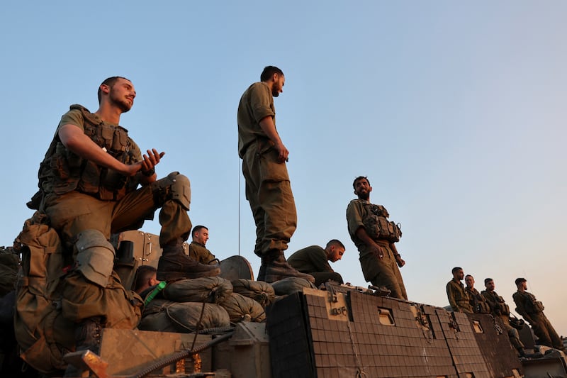 Israeli soldiers stand on an armoured personnel carrier near the Israel-Gaza border, in southern Israel. Reuters