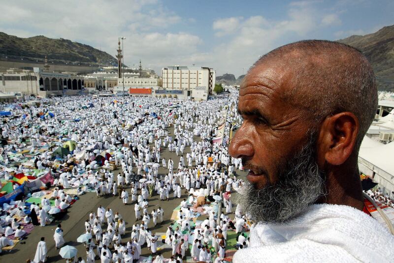 A pilgrim stands on a bridge overlooking Mina, where about two million Muslims camped during Hajj in January 2004.